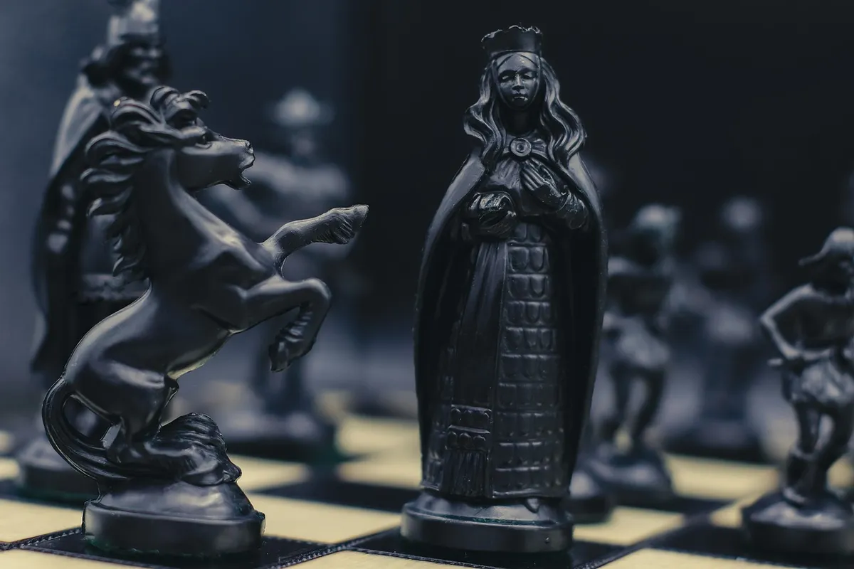 chess, black chess pieces, fantasy chess, strategy game, queen chess piece, knight, horse piece, battle of minds, board game, dramatic lighting, chess art, clos